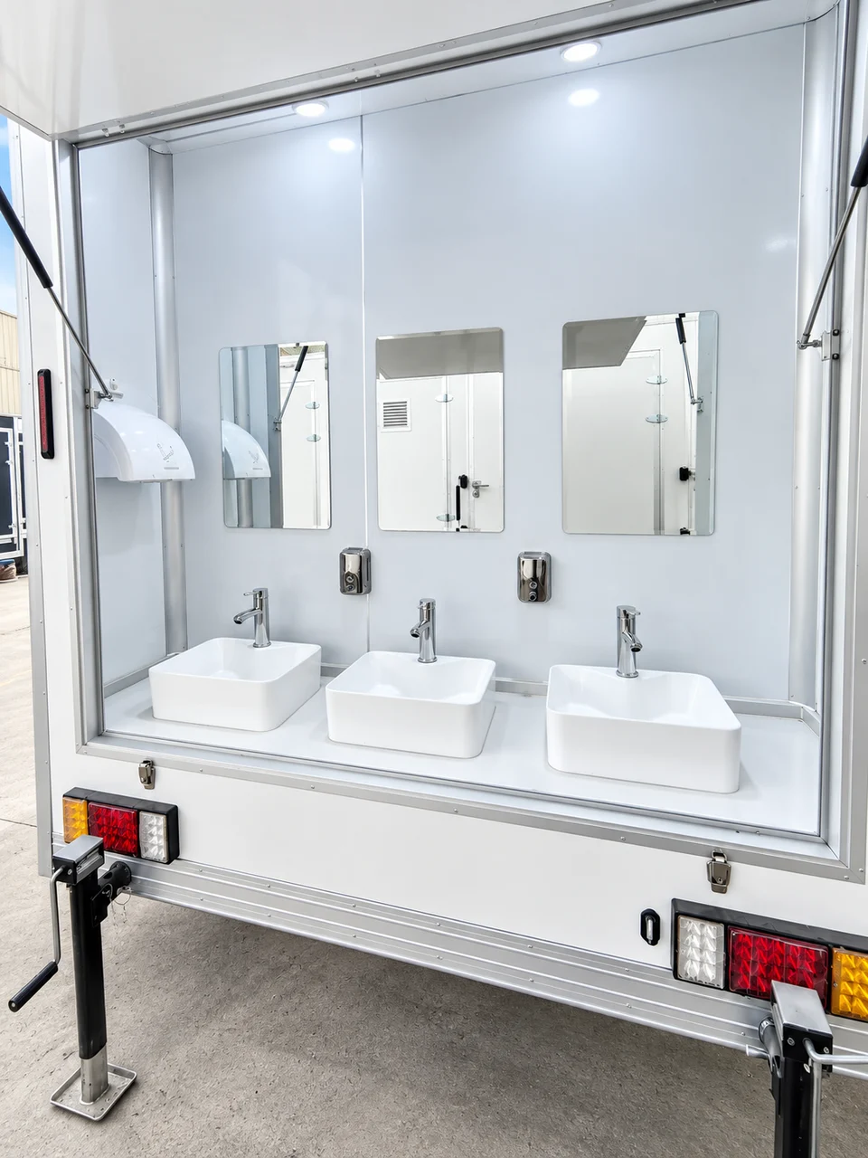 Externally accessible sinks and mirrors on the shower trailer