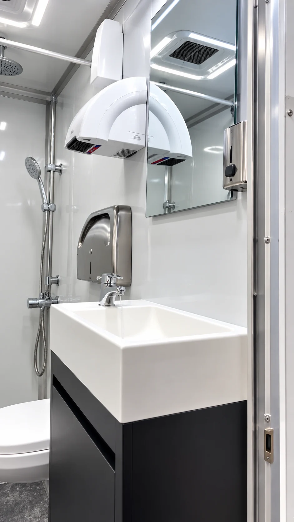 Wash basin and mirror inside the shower-restroom combination trailer