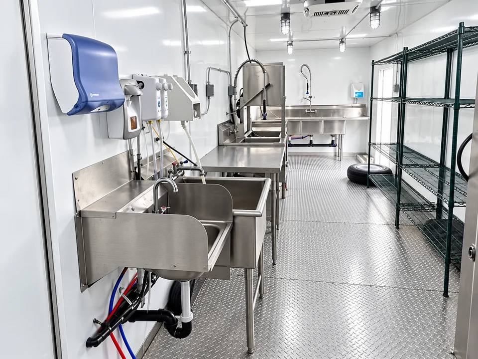 Wash sinks and shelving inside a dishwashing trailer